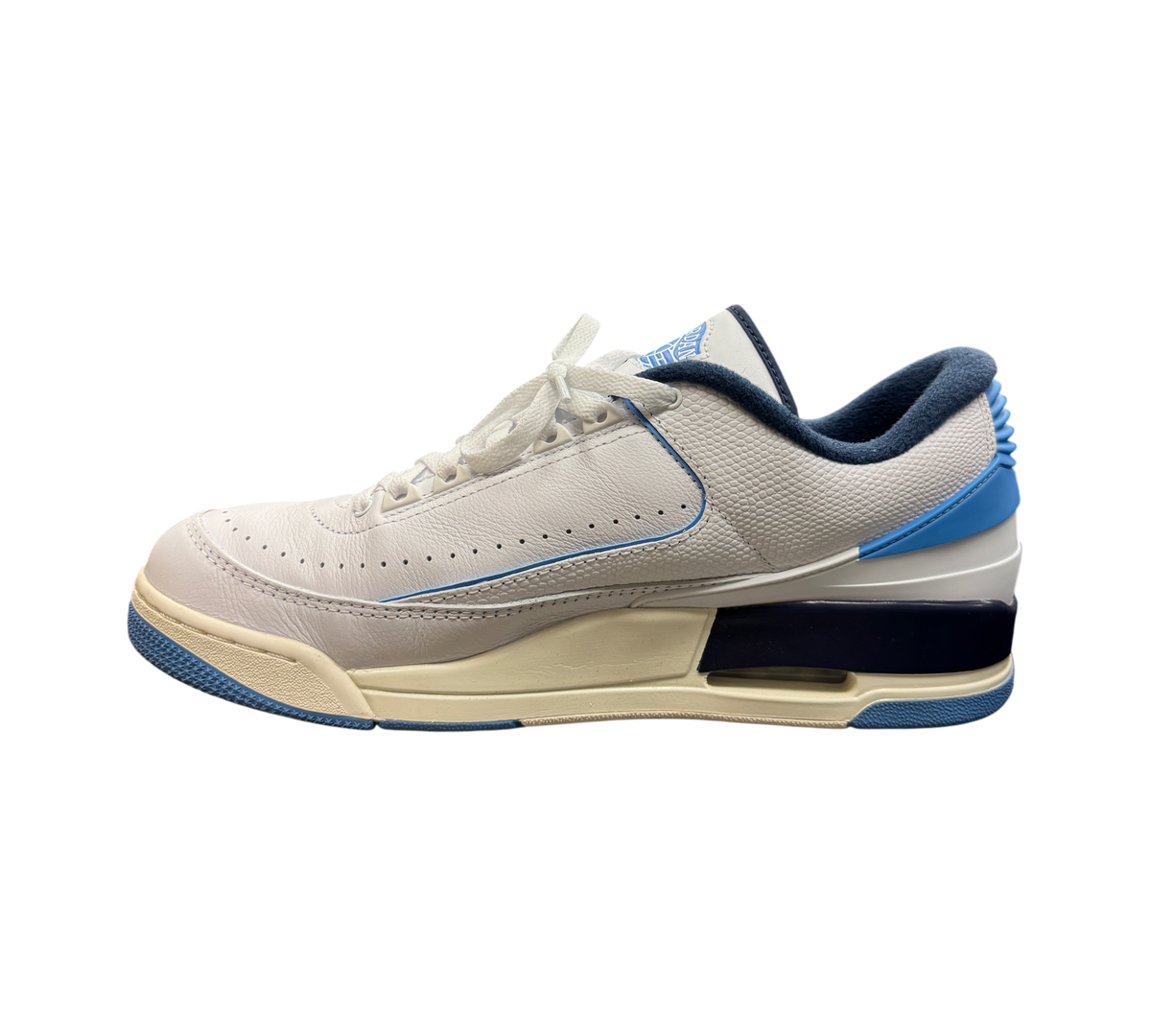 Genesis Boutique Jordan 2/3 UNC sneakers in white leather with university blue and navy accents on a glass display