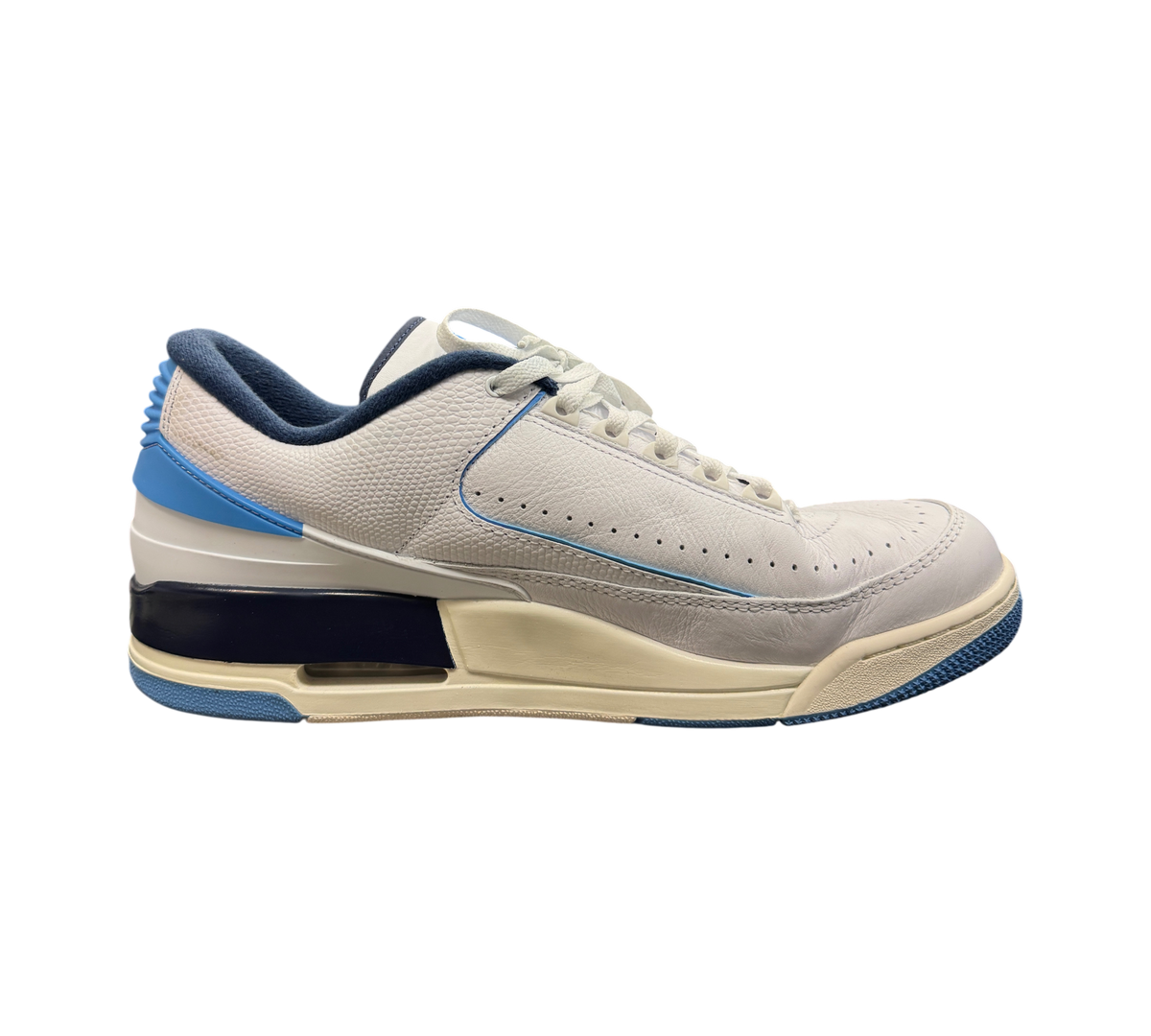 Genesis Boutique Jordan 2/3 UNC sneakers in white leather with university blue and navy accents on a glass display