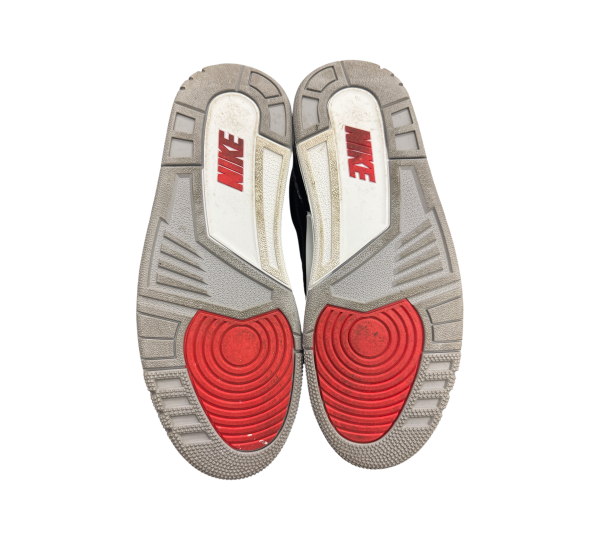 Genesis Boutique used Jordan 3 Black Cement sneakers showing the grey, white, and red rubber outsoles with Nike branding.