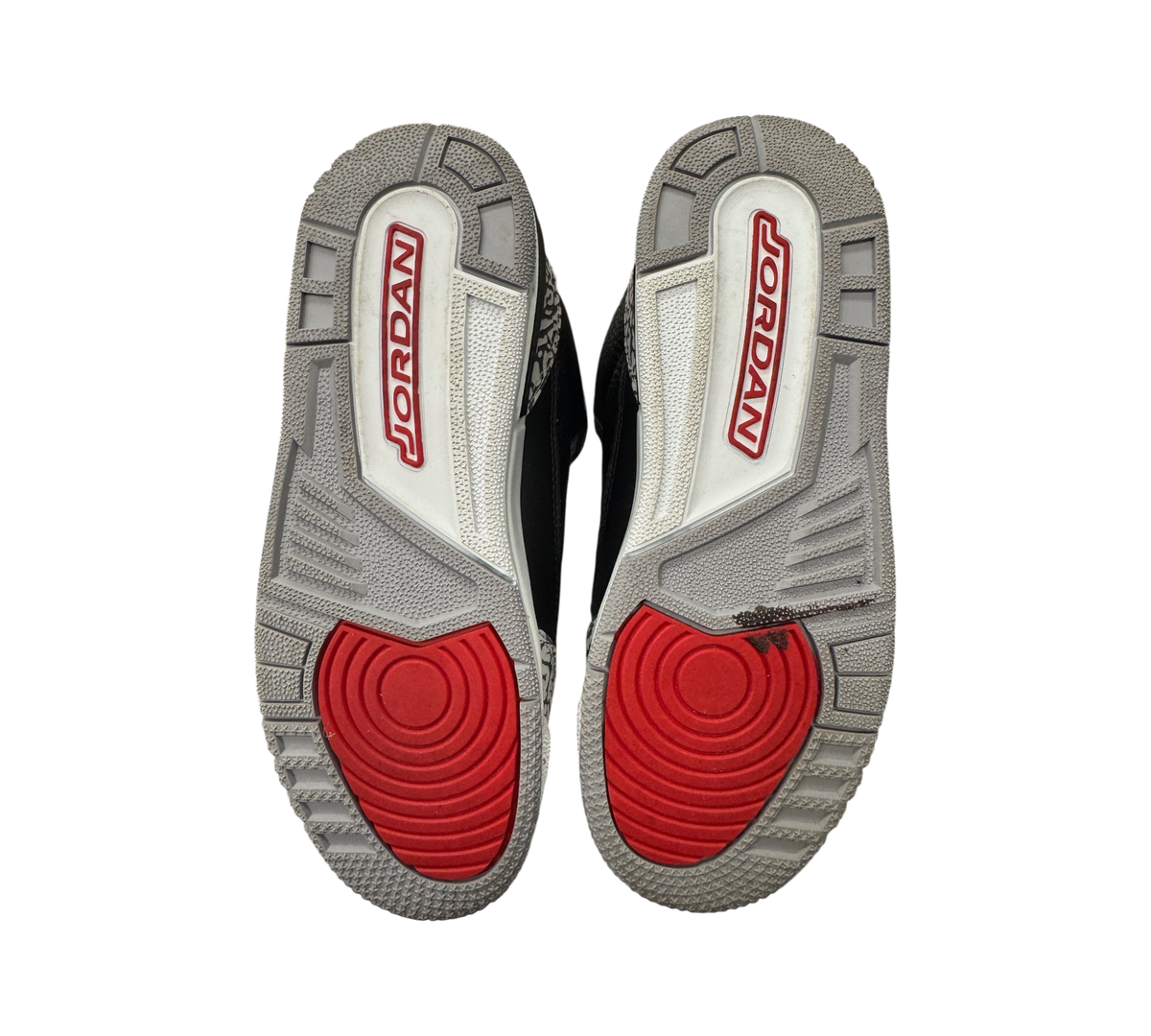 Genesis Boutique used Jordan 3 Black Cement GS sneakers showing grey and red rubber outsoles with Jordan branding.
