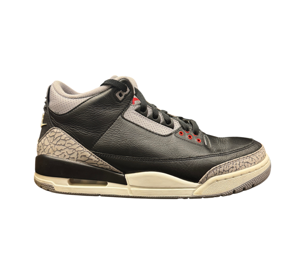 Genesis Boutique Jordan 3 Black Cement sneakers featuring black leather, grey elephant print, and red eyelet details.