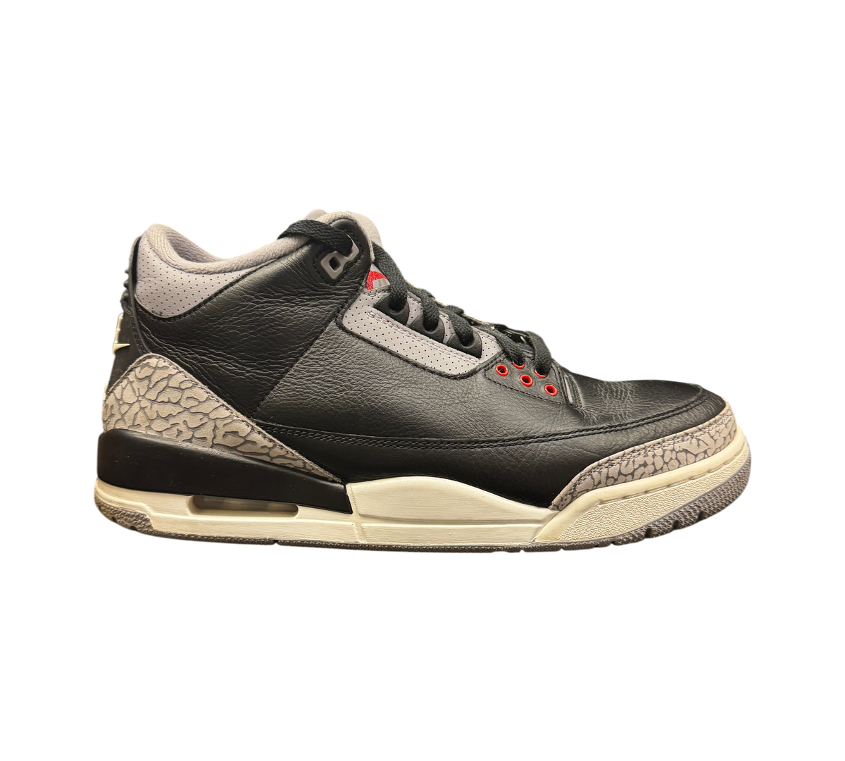Genesis Boutique Jordan 3 Black Cement sneakers featuring black leather, grey elephant print, and red eyelet details.