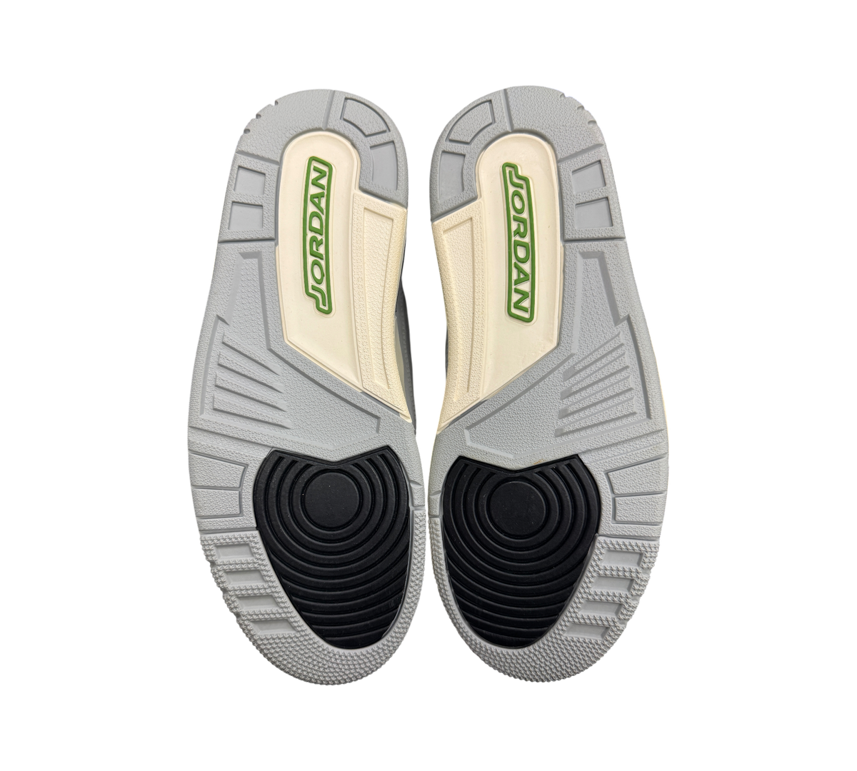 Genesis Boutique used Jordan 3 Chlorophyll sneakers showing the grey, black, and green rubber outsoles.