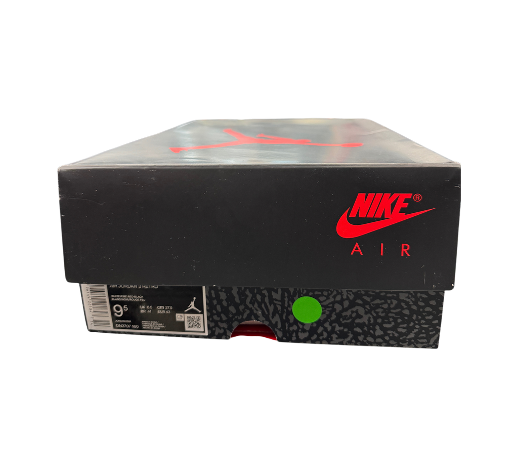 Genesis Boutique Jordan 3 Fire Red shoe box with Nike Air branding, displayed in a retail store setting.