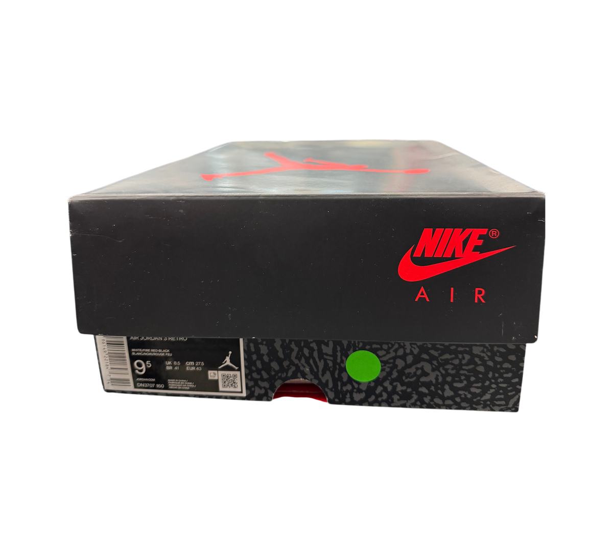 Genesis Boutique Jordan 3 Fire Red shoe box with Nike Air branding, displayed in a retail store setting.