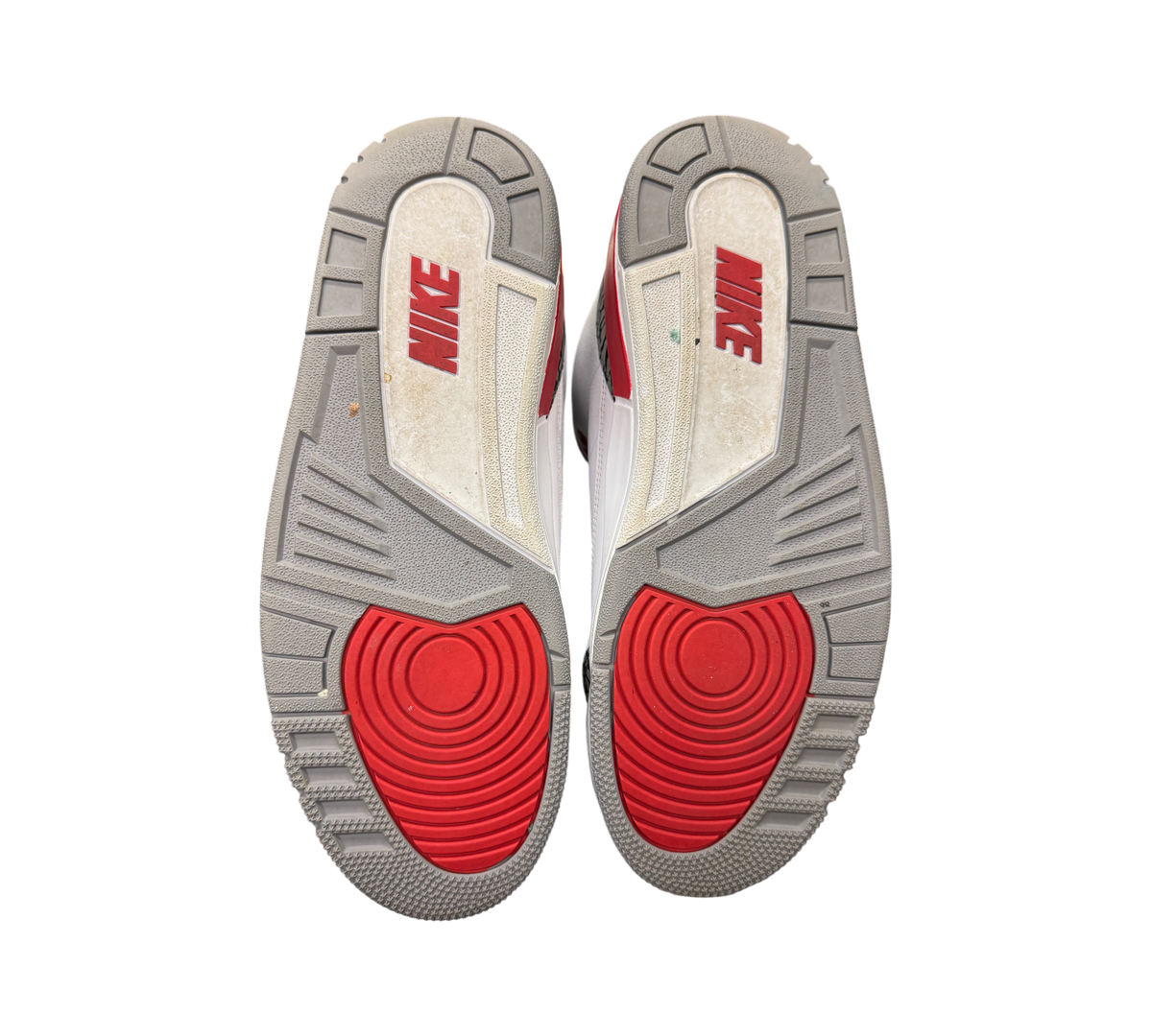 Genesis Boutique pre-owned Jordan 3 Fire Red sneakers showing grey and red rubber outsoles with Nike branding.