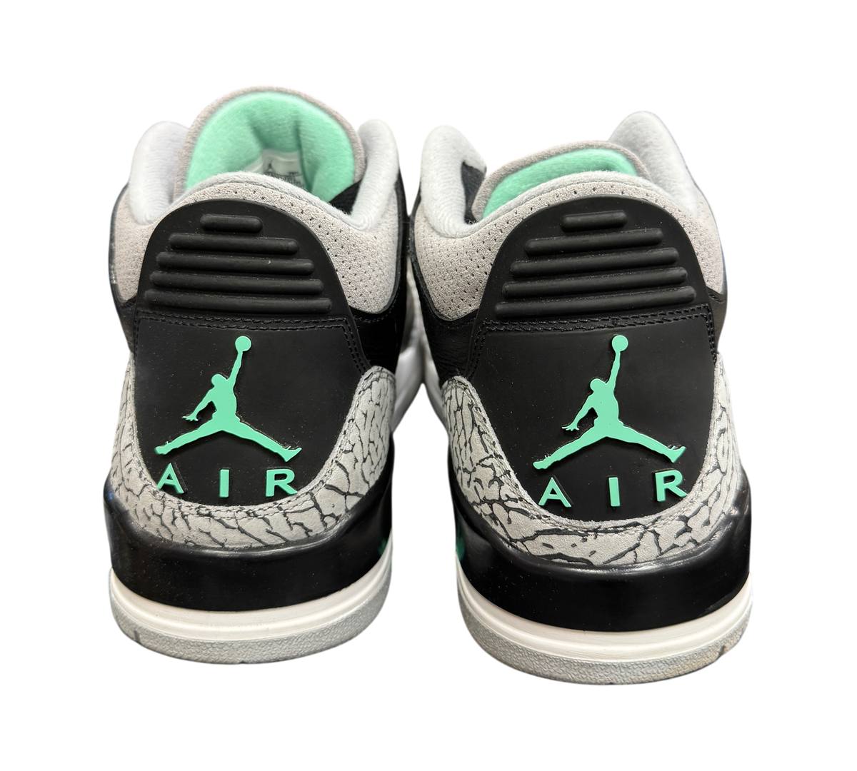 Genesis Boutique Jordan 3 Green Glow sneakers showing black heels with elephant print and green Jumpman logos