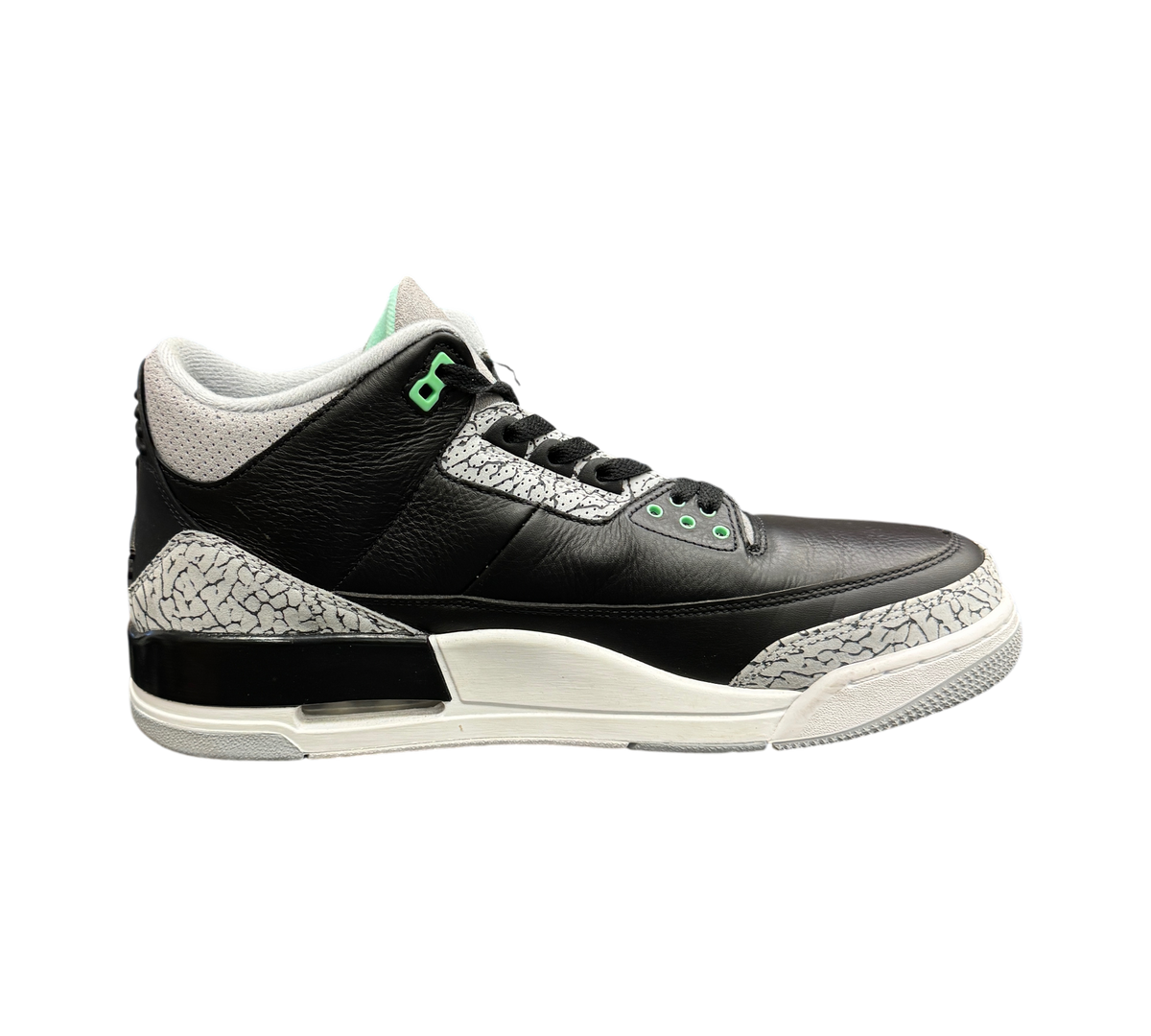 Genesis Boutique Jordan 3 Green Glow sneakers in black and grey leather with iconic elephant print and green accents.