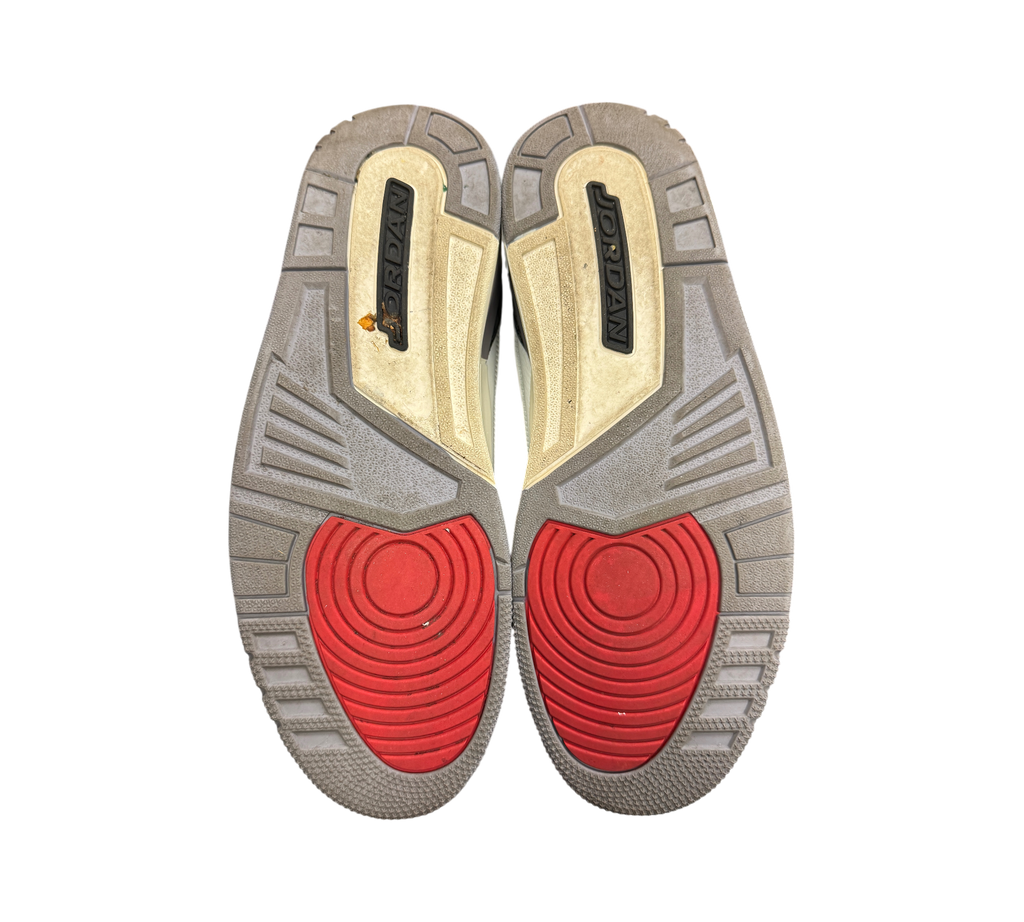 Genesis Boutique Jordan 3 Grey Cement sneaker outsoles showing red circular traction patterns and grey rubber tread