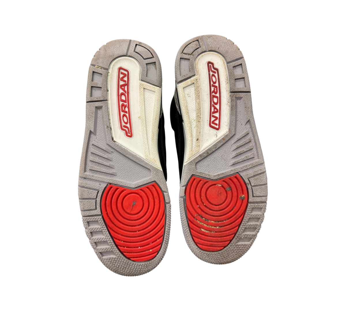 Genesis Boutique Jordan 3 GS Black Cement Reimagined sneakers showing grey and red rubber outsoles with Jordan logo