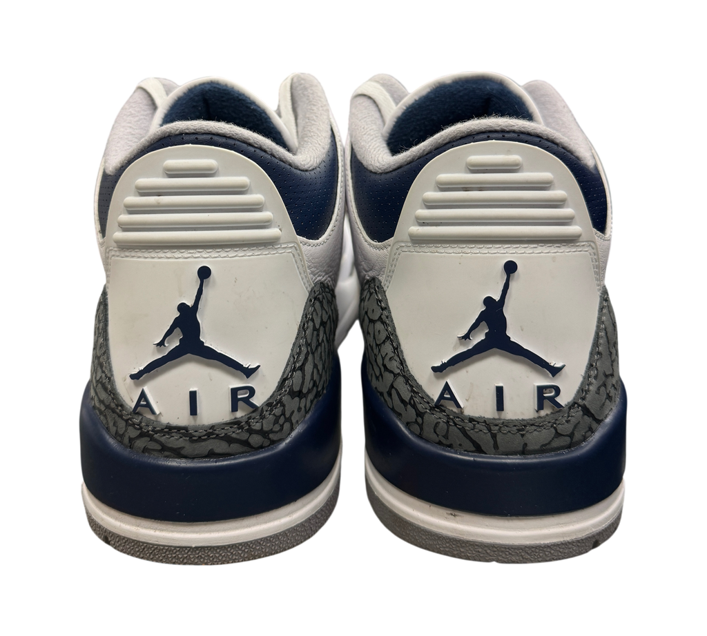 Genesis Boutique Jordan 3 Midnight Navy sneakers showing the white and navy heel tabs with Jumpman Air branding