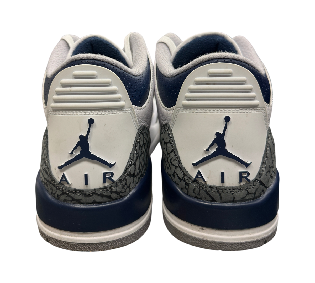 Genesis Boutique Jordan 3 Midnight Navy sneakers showing the white and navy heel tabs with Jumpman Air branding