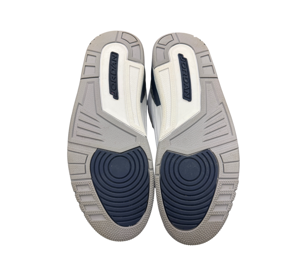 Genesis Boutique Jordan 3 Midnight Navy sneakers showing the grey and navy blue rubber outsoles with Jordan branding.