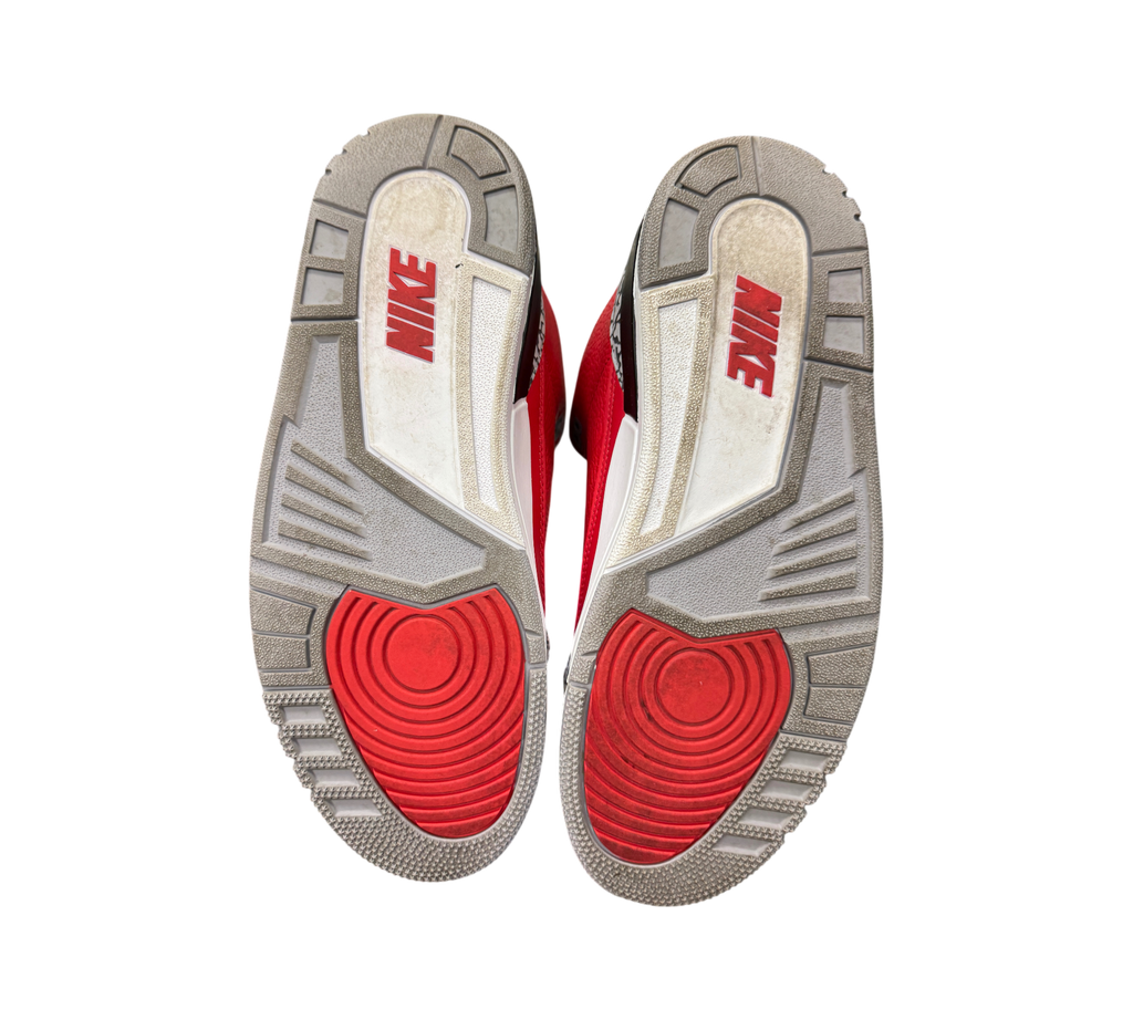 Genesis Boutique used Jordan 3 Unite Red Cement sneakers showing the grey, white, and red rubber outsoles.
