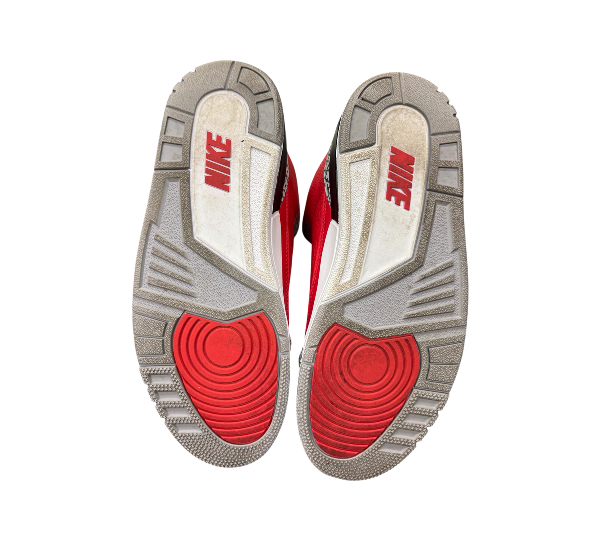 Genesis Boutique used Jordan 3 Unite Red Cement sneakers showing the grey, white, and red rubber outsoles.
