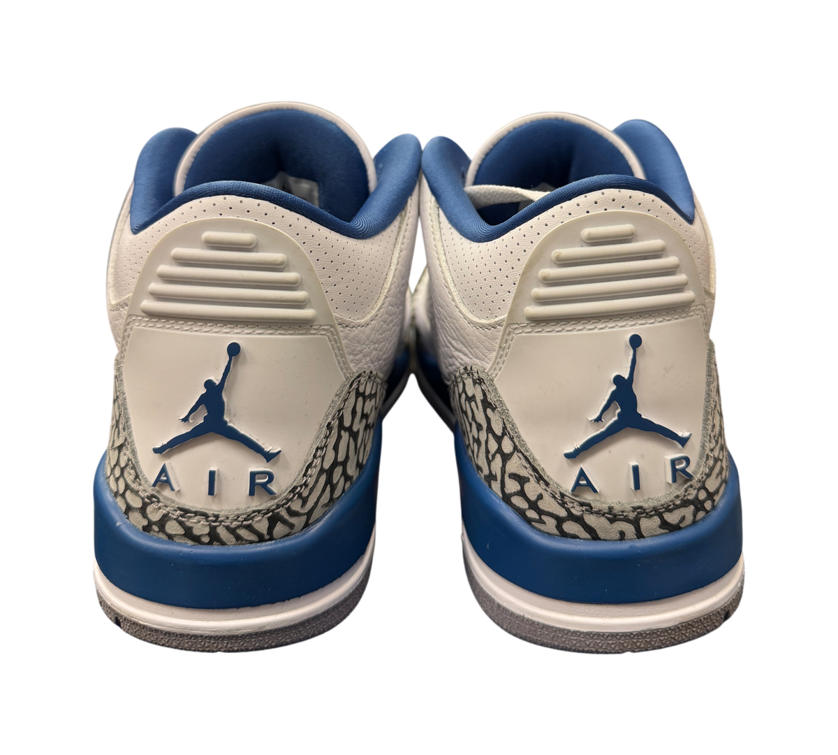 Genesis Boutique Jordan 3 Wizard sneakers showing the white leather heel, blue Jumpman logo, and elephant print trim.