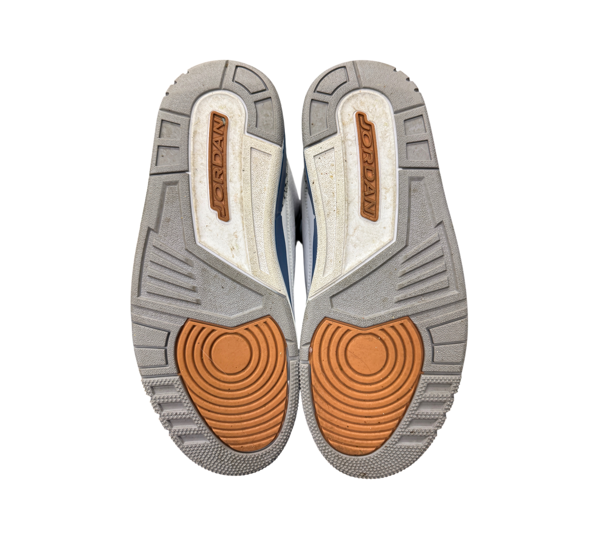 Genesis Boutique used Jordan 3 Wizard sneaker outsoles showing grey, white, and orange traction patterns.