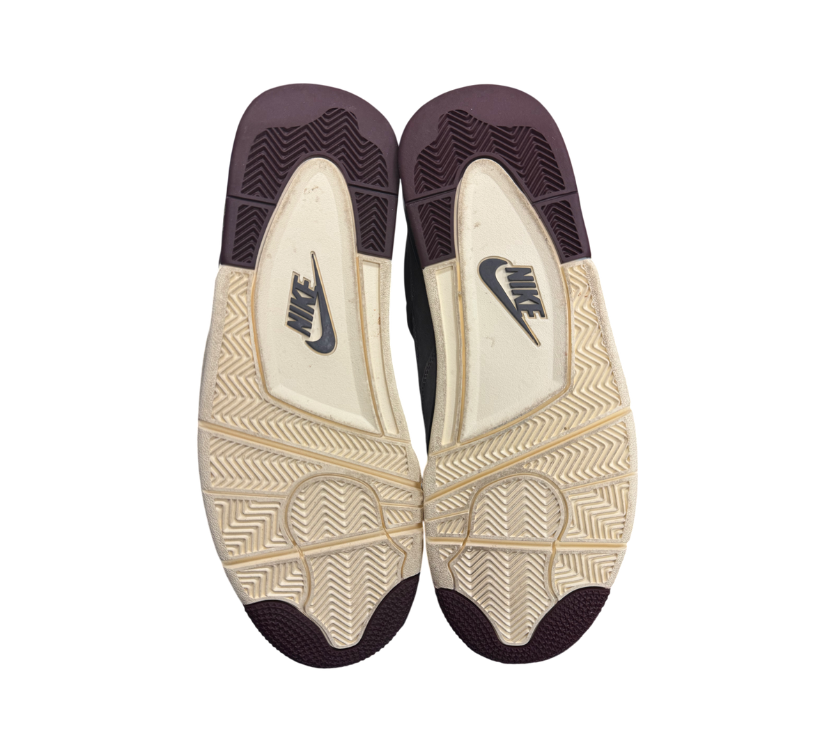Genesis Boutique used Jordan 4 A Ma Maniere sneakers showing the cream and burgundy rubber outsoles with Nike branding.