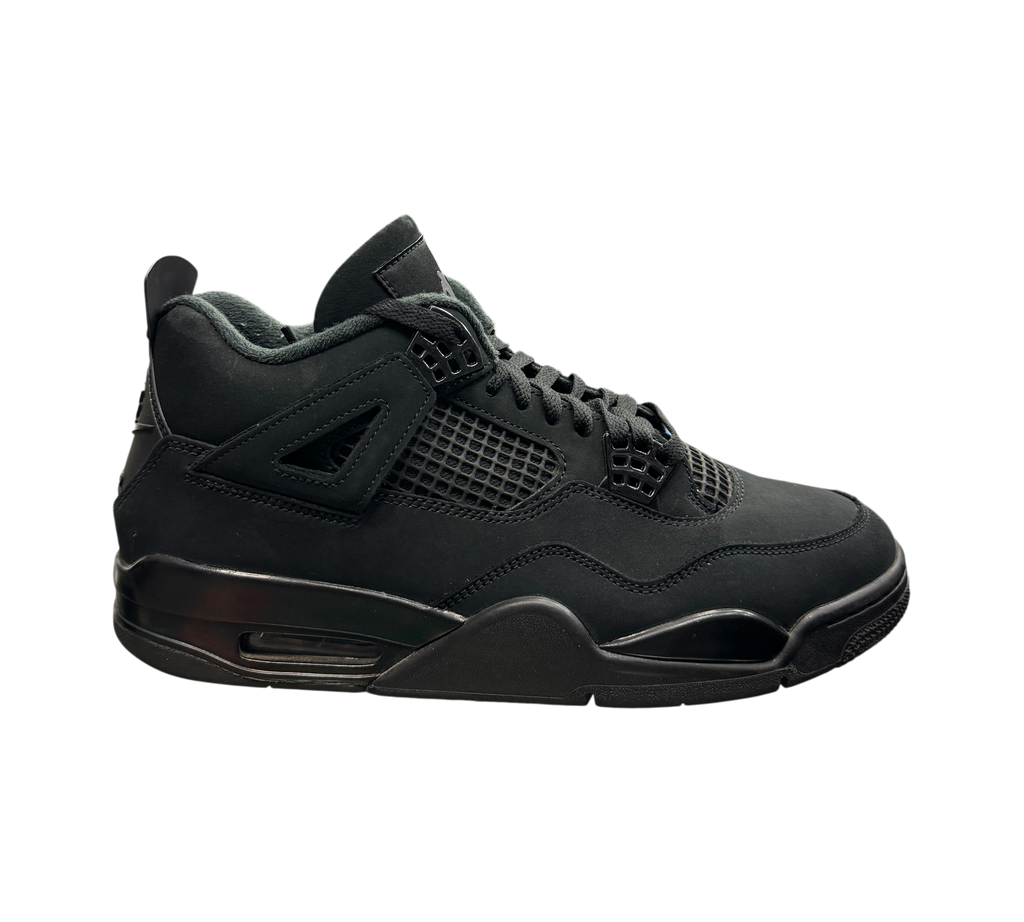 Genesis Boutique used Jordan 4 Black Cat sneakers in all-black nubuck leather on a glass display shelf.