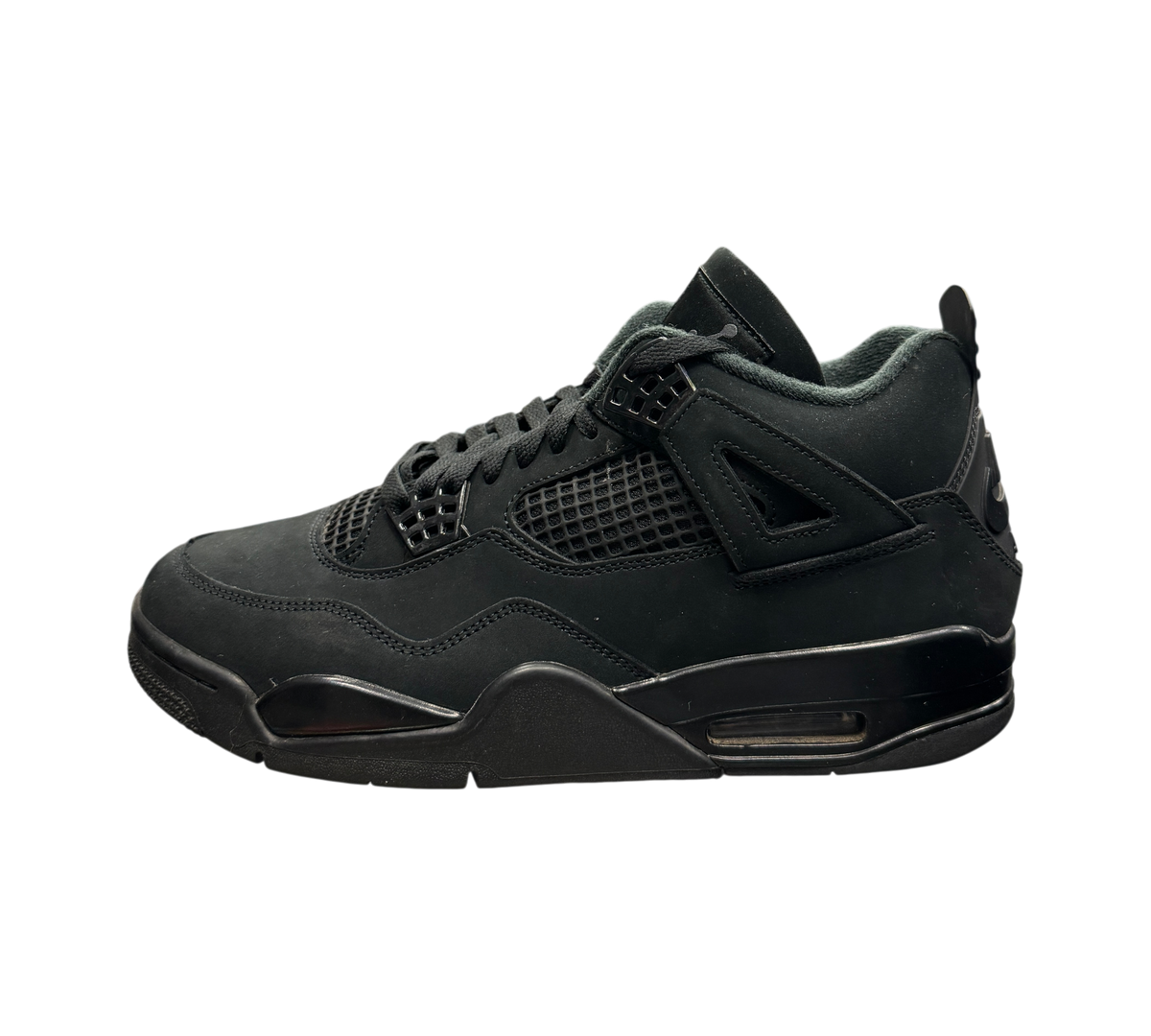 Genesis Boutique Jordan 4 Black Cat sneakers in all-black nubuck leather displayed on a glass counter in a store