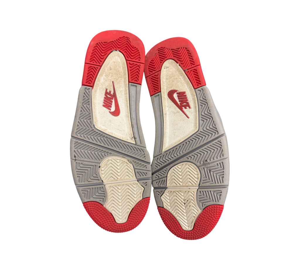 Genesis Boutique used Jordan 4 2019 Bred sneakers showing the red, grey, and white rubber outsoles with Nike branding.