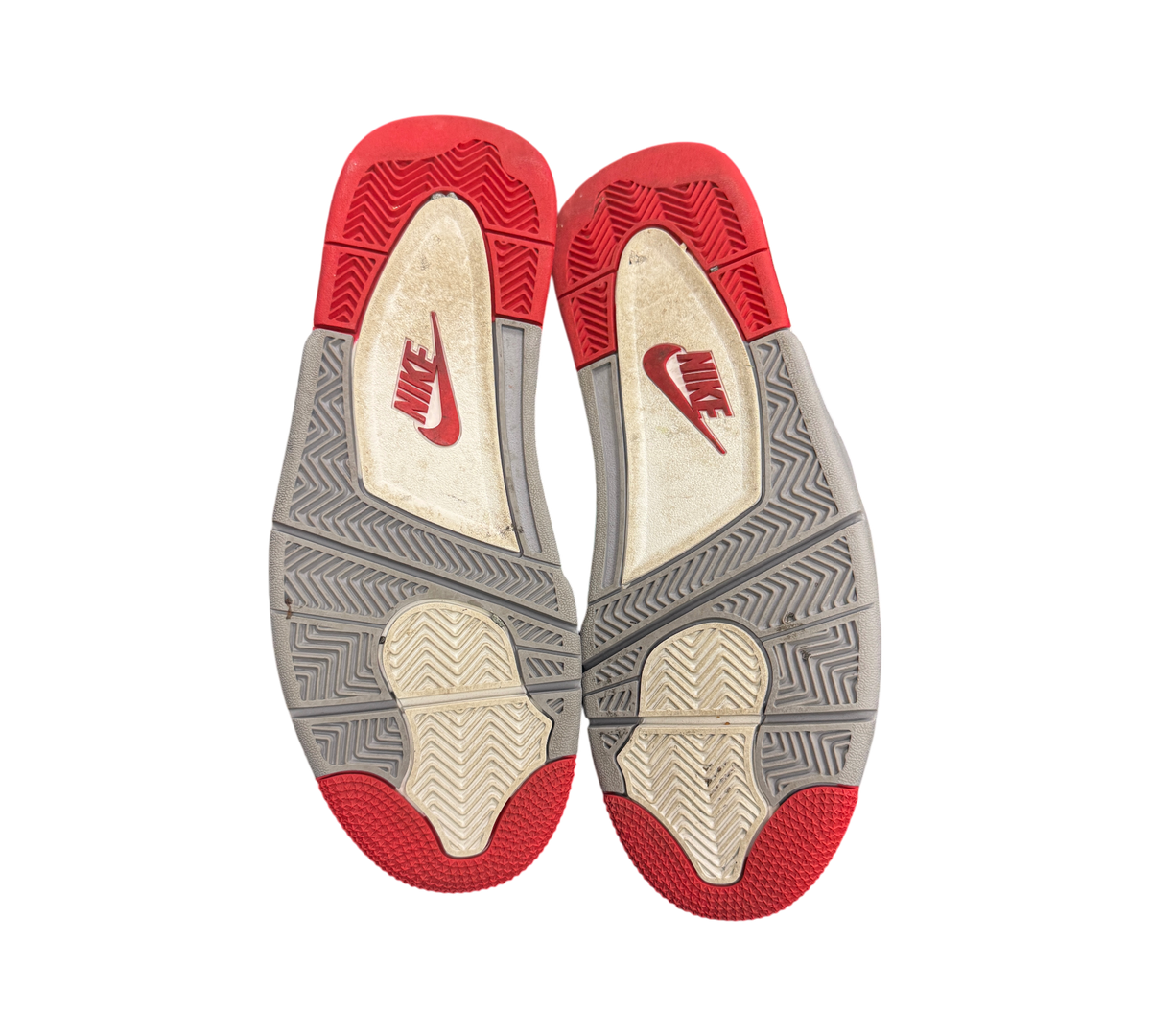 Genesis Boutique used Jordan 4 2019 Bred sneakers showing the red, grey, and white rubber outsoles with Nike branding.