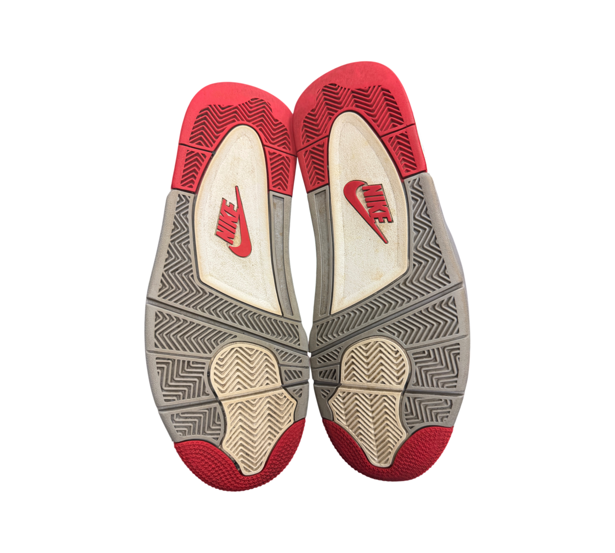 Genesis Boutique used Jordan 4 Bred Reimagined sneakers showing red and grey rubber outsoles with Nike branding