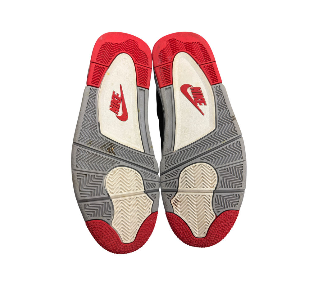 Genesis Boutique used Jordan 4 Bred 2019 sneakers showing red, grey, and white rubber outsoles with Nike branding.