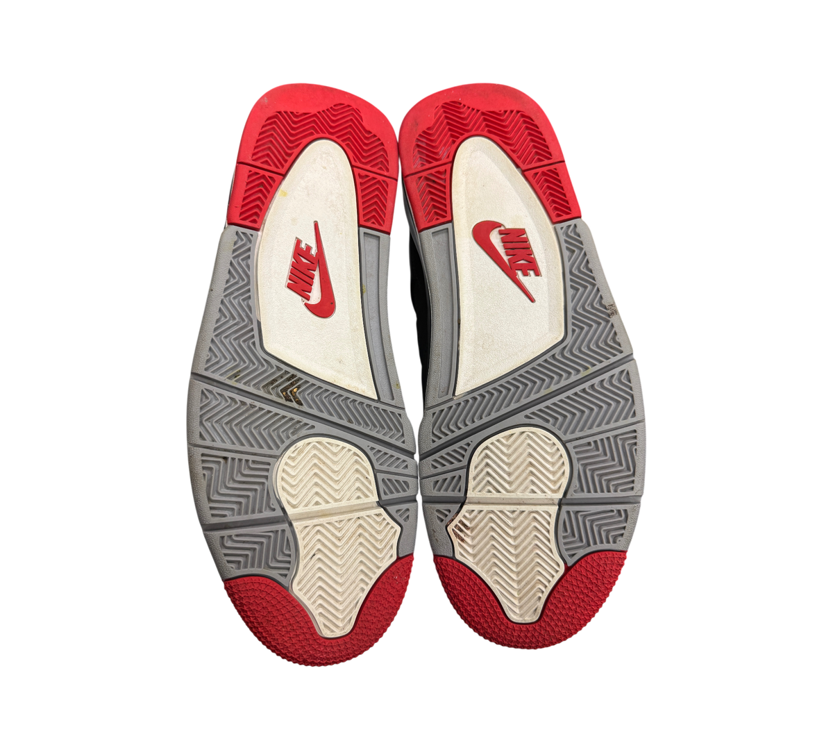 Genesis Boutique used Jordan 4 Bred 2019 sneakers showing red, grey, and white rubber outsoles with Nike branding.