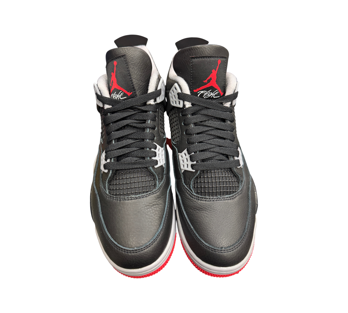 Genesis Boutique Jordan 4 Bred Reimagined sneakers in black leather with red Jumpman logo and white midsole details.