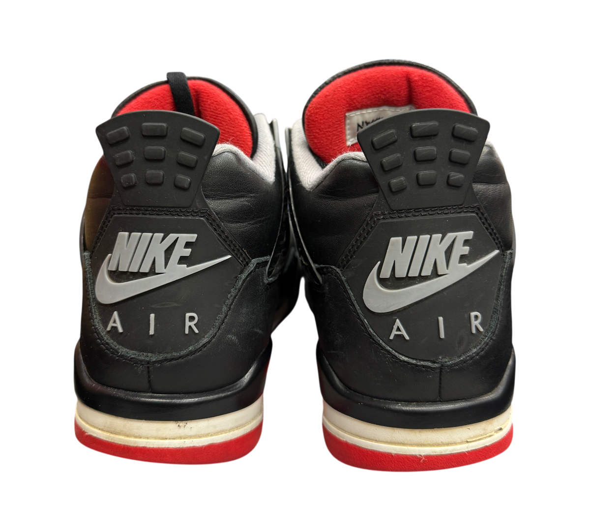 Genesis Boutique Jordan 4 Bred Reimagined sneakers showing the black leather heel tabs with Nike Air branding.