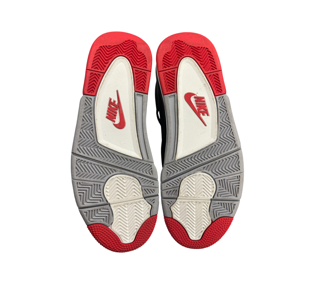 Genesis Boutique Jordan 4 Bred Reimagined sneakers showing the red, grey, and white rubber outsoles with Nike branding.