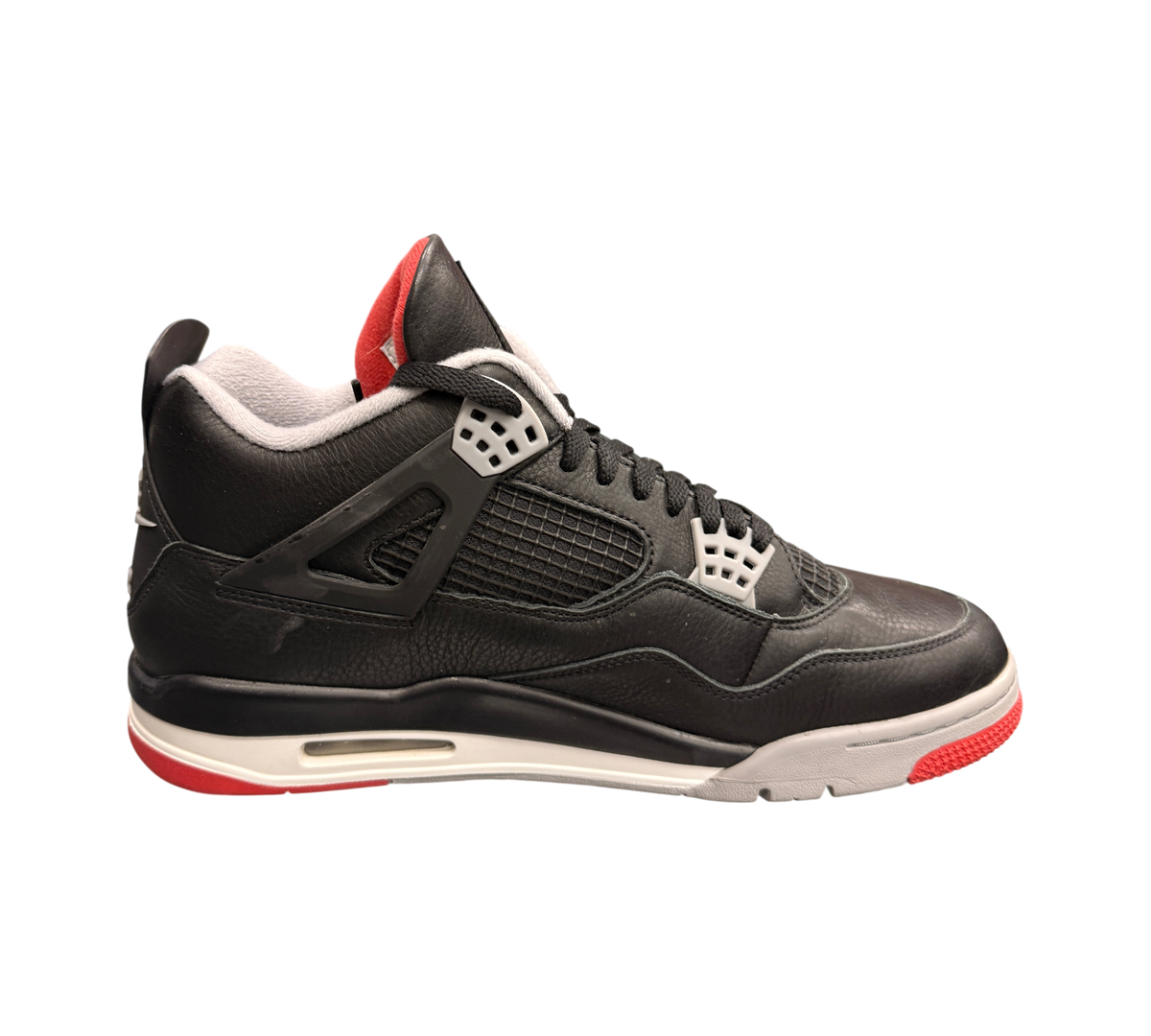 Genesis Boutique Jordan 4 Bred Reimagined sneakers in black leather with red accents and white laces. Side profile view.