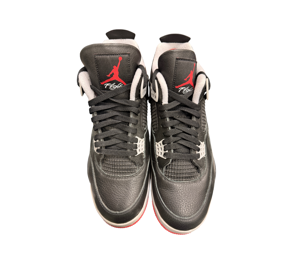Genesis Boutique Jordan 4 Bred Reimagined sneakers in black leather with red Jumpman logo and white accents.