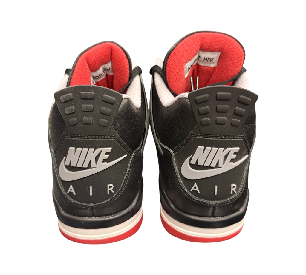 Genesis Boutique Jordan 4 "Bred Reimagined" sneakers with black leather, red lining, and Nike Air branding on the heel.