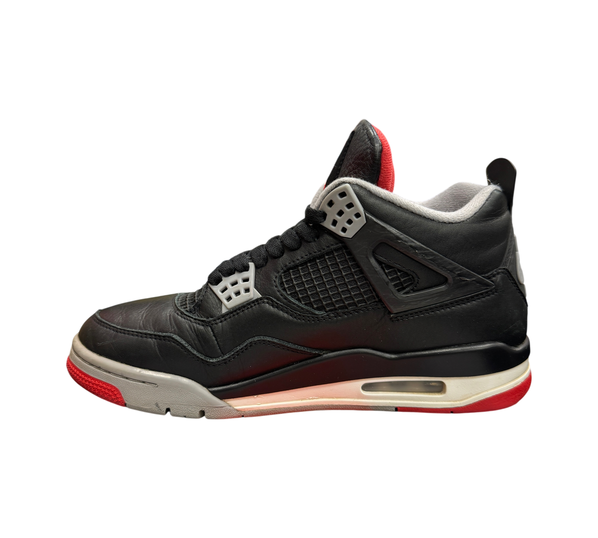Genesis Boutique Jordan 4 Bred Reimagined sneakers in black leather with red and grey accents on a speckled shoebox