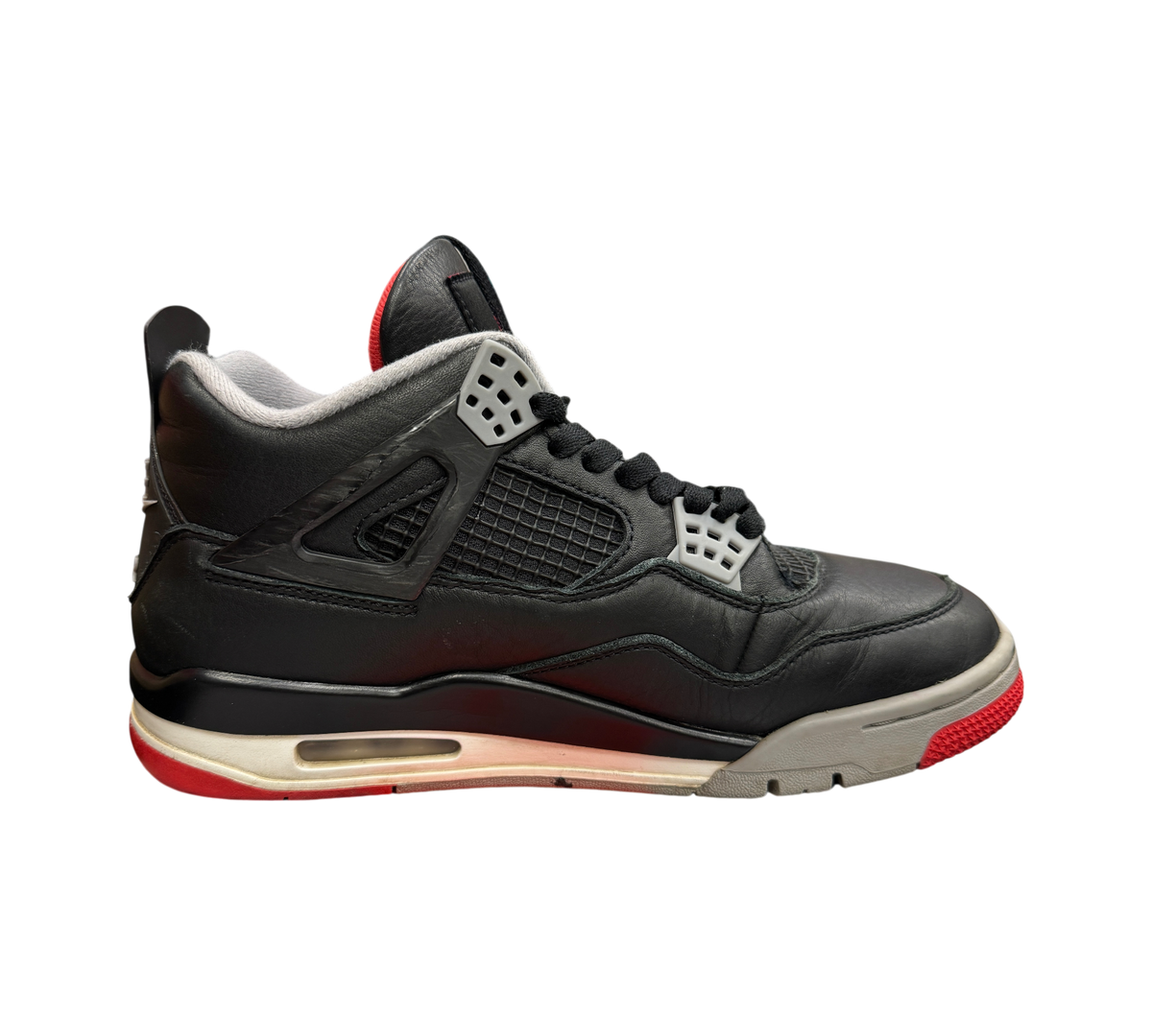 Genesis Boutique Jordan 4 Bred Reimagined sneakers in black leather with grey and red accents on a branded shoebox