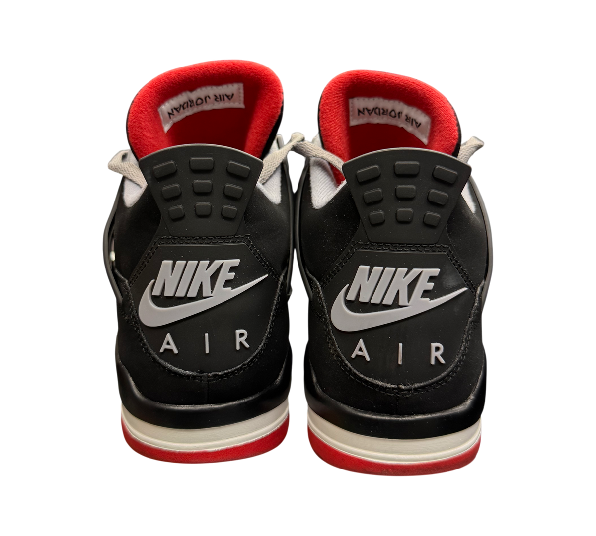Genesis Boutique Jordan 4 "Bred" 2019 sneakers with black, red, and white accents. Features Nike Air branding.