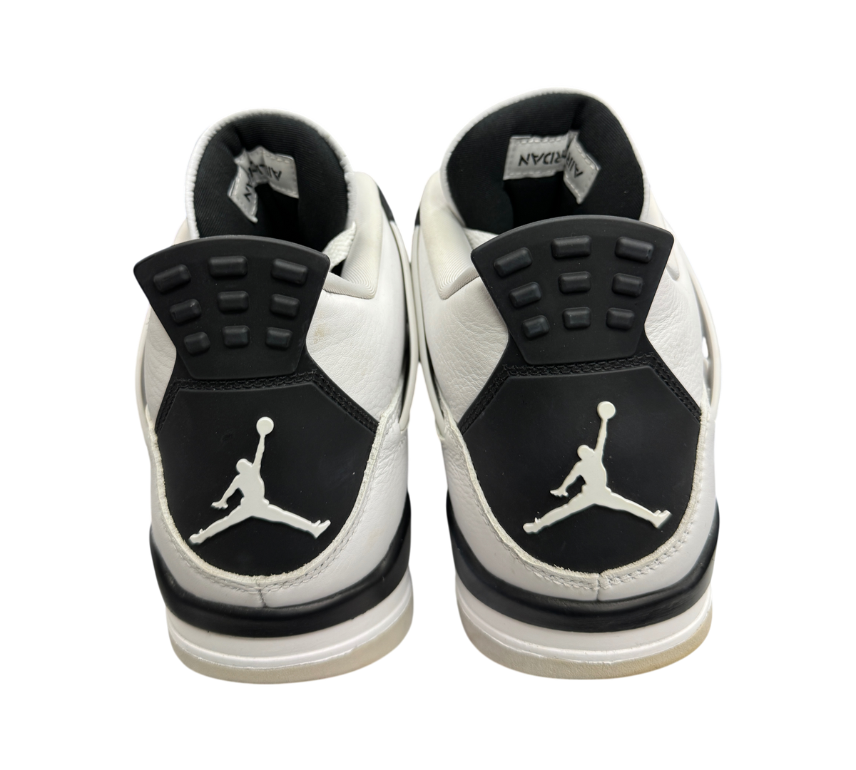Genesis Boutique Jordan 4 Military Black sneakers showing the white leather heels with black Jumpman logos