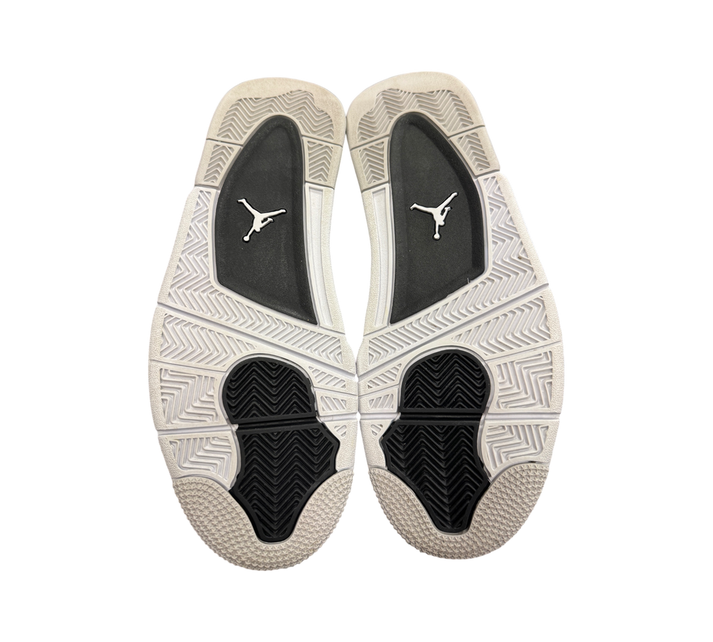 Genesis Boutique used Jordan 4 Military Black sneakers showing the white, black, and grey rubber outsoles