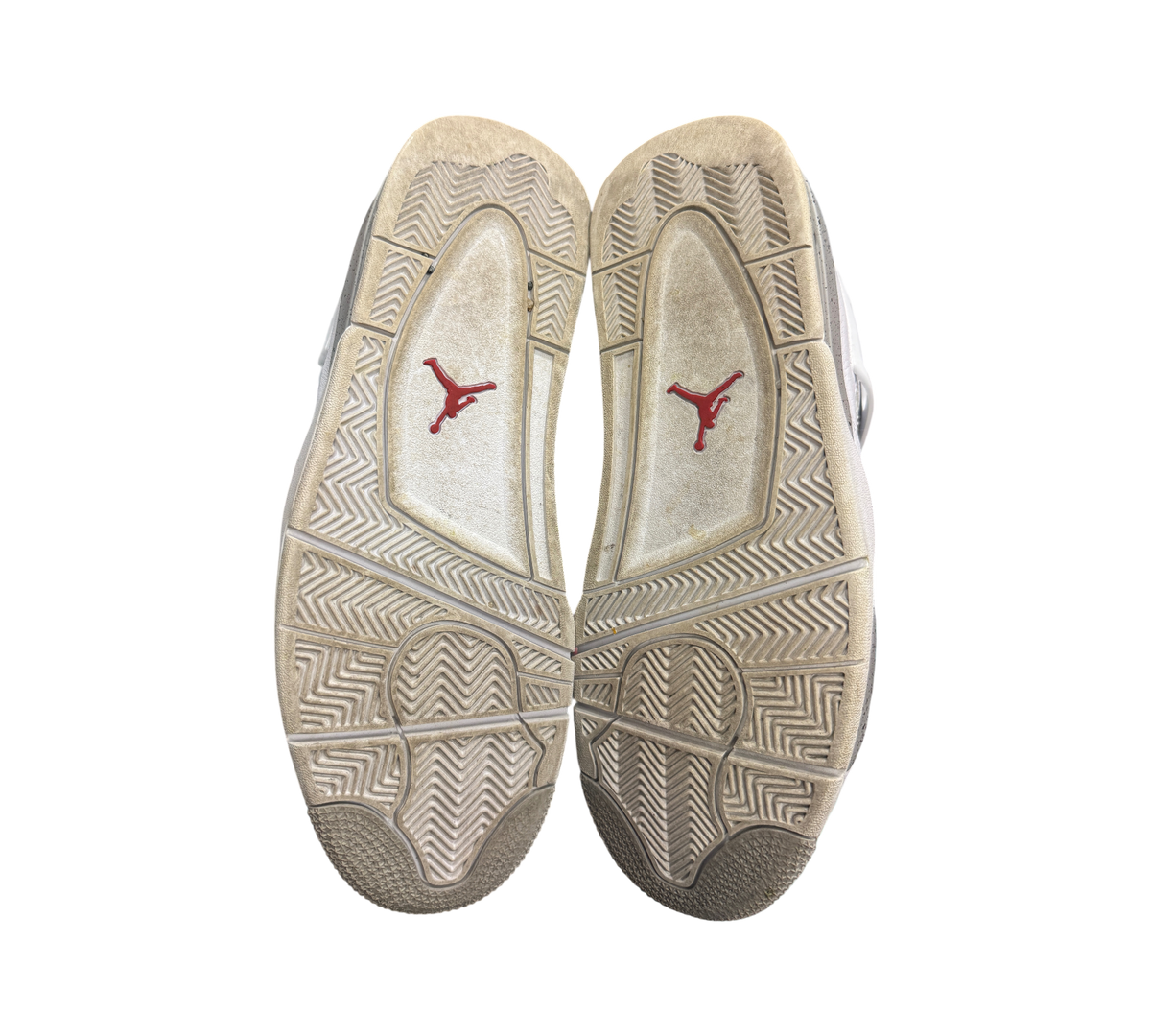 Genesis Boutique used Jordan 4 Oreo sneakers showing the worn rubber outsoles with red Jumpman logos