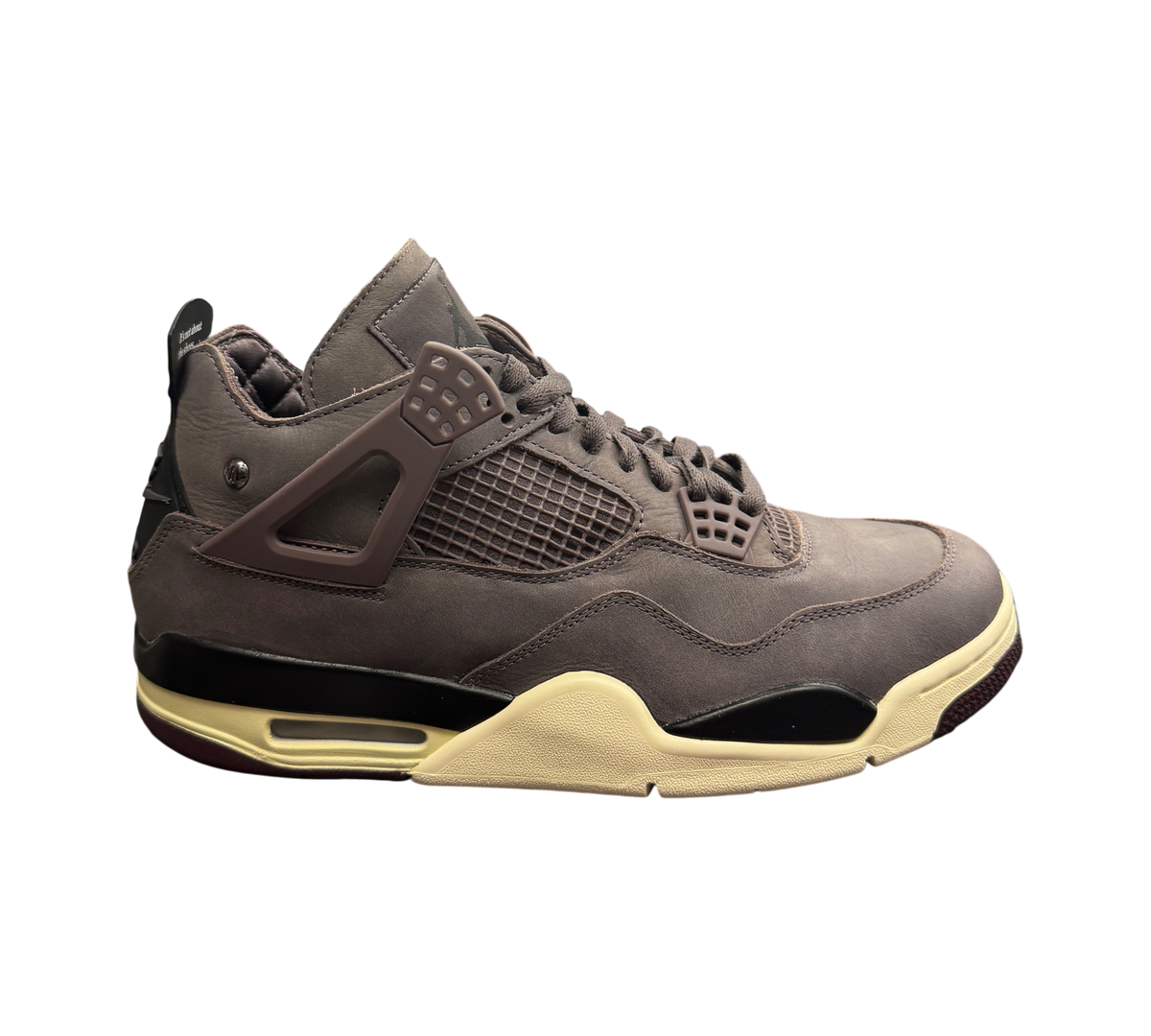 Genesis Boutique Jordan 4 A Ma Maniere Violet Ore sneakers in dark purple nubuck with cream midsole in retail store.
