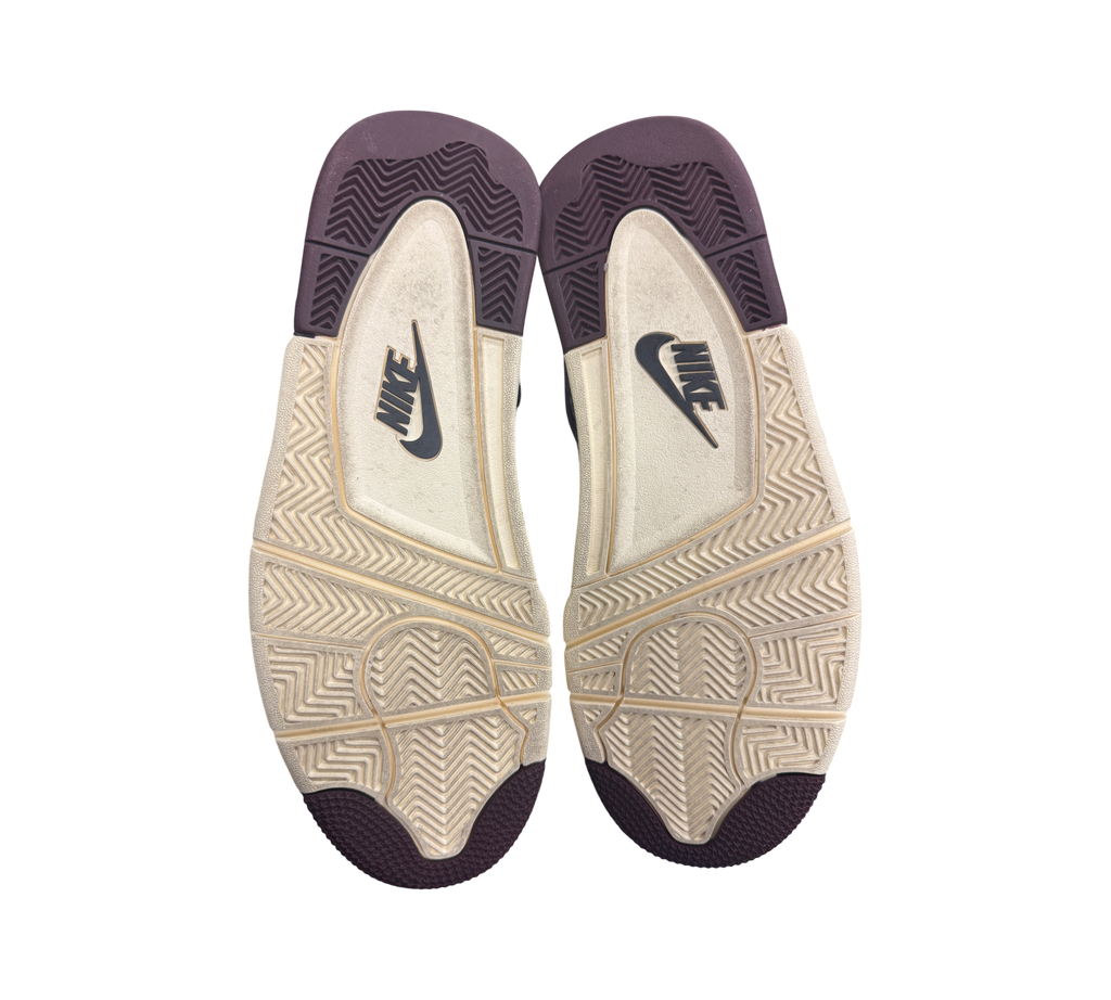 Genesis Boutique used Jordan 4 A Ma Maniere Violet Ore sneakers showing the cream and dark purple rubber outsoles.