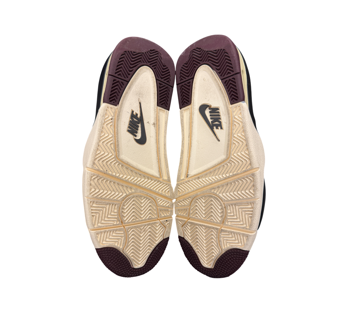 Genesis Boutique Jordan 4 A Ma Maniere Violet Ore sneaker outsoles showing cream and burgundy tread pattern
