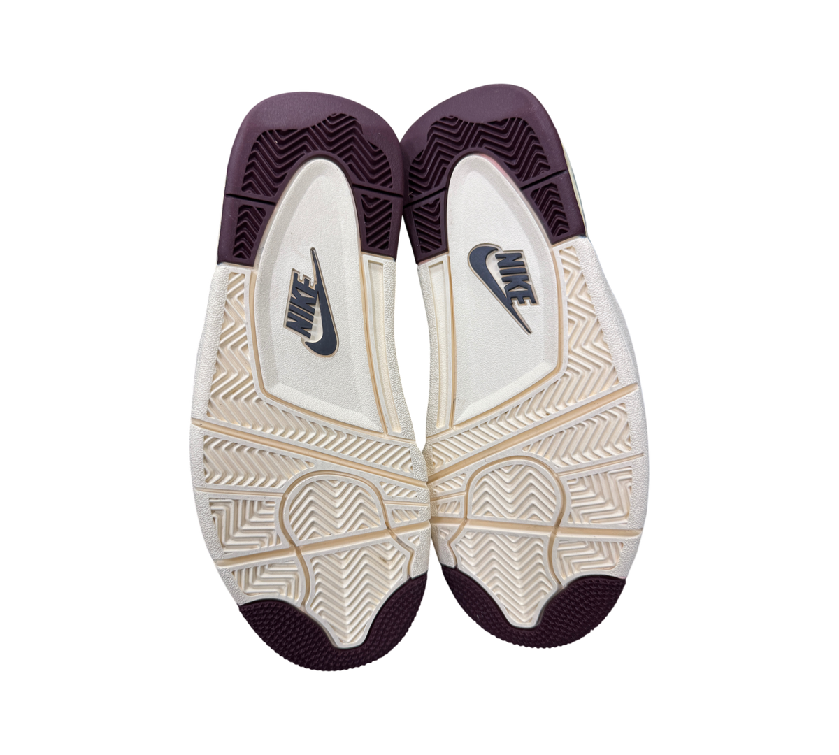 Genesis Boutique Jordan 4 A Ma Maniere Violet Ore sneakers showing the cream and dark purple rubber outsoles