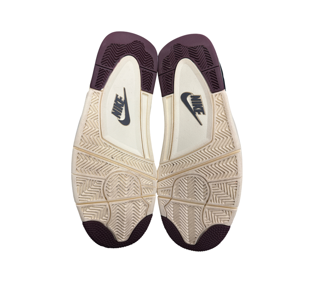 Genesis Boutique Jordan 4 A Ma Maniere Violet Ore sneaker outsoles showing cream and dark purple rubber tread pattern