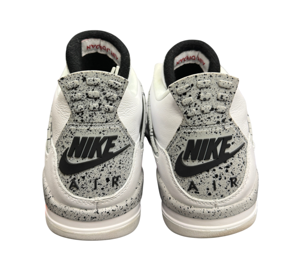 Genesis Boutique Jordan 4 2016 White Cement sneakers showing the grey speckled heel tabs with Nike Air branding.