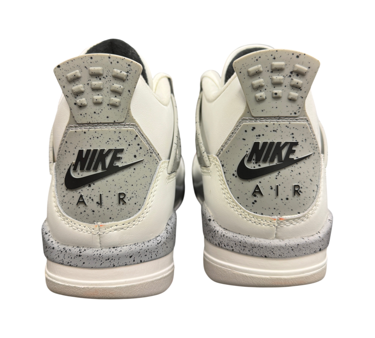 Genesis Boutique Jordan 4 GS White Cement 2025 sneakers showing the grey speckled heel tabs with Nike Air branding