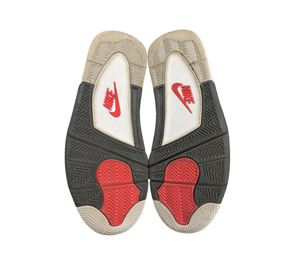 Genesis Boutique Jordan 4 2016 White Cement sneaker outsoles showing black, white, and red tread patterns