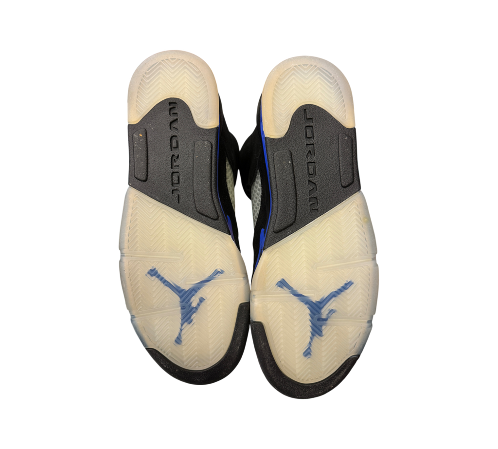 Genesis Boutique Jordan 5 GS Racer Blue sneakers showing the translucent outsoles with blue Jumpman logos